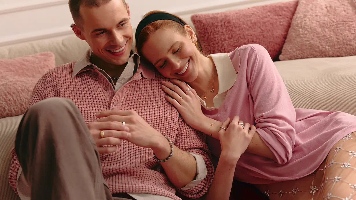 Two people playing cards on the bed